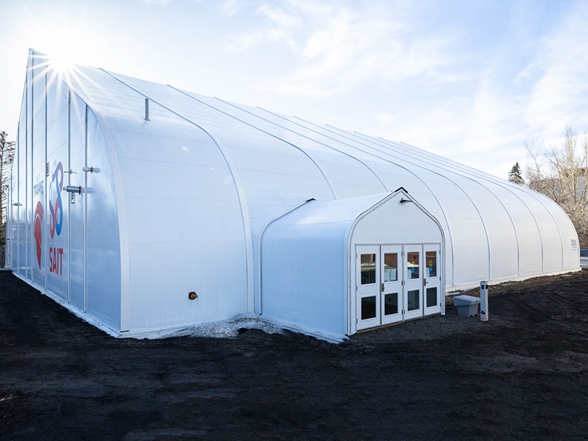 White fabric building with large graphics on the Sprung structure gymnasium